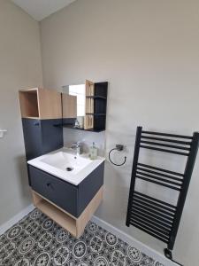 a bathroom with a sink and a mirror at The Glen Lodges, Muriel Cabin in Auckingill +16 photos