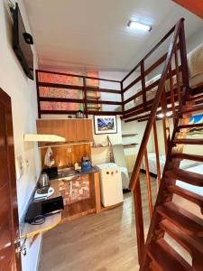 a small kitchen with a stove and a staircase at Hospedaria Camarão da ilha in Fernando de Noronha