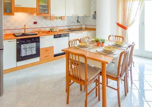 a kitchen with a wooden table and chairs at Dimora La Cupa in Monteroni di Lecce
