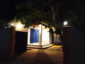 a house with a gate at night with lights at Cozy Vibe Villa in Arugam Bay