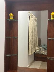 a room with a closet with a mirror and a bed at Satgiri Nest House in Chikmagalūr +23 photos