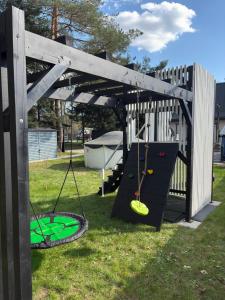a playground with a swing and a trampoline at Domek Marzenie in Radawa +83 photos