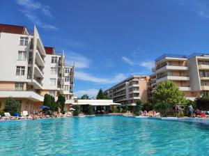 a swimming pool in front of some apartment buildings at Luxury Penthouse Studio with Outdoor Hot Tub and Panoramic Views in Sunny Beach