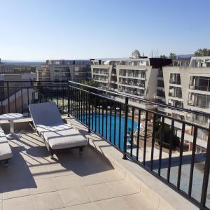 a balcony with a view of a pool and buildings at Luxury Penthouse Studio with Outdoor Hot Tub and Panoramic Views in Sunny Beach
