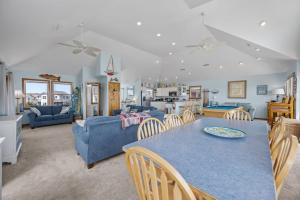 a kitchen and living room with a table and chairs at 7680 - Sandy Bottom in Avon