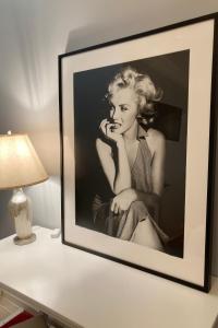 a picture of a woman sitting on a table at The Hotel Hollywood in Los Angeles