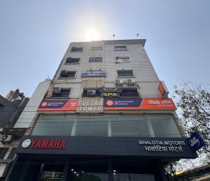 a tall building with signs on the side of it at Hotel Aurelia Heights in Jamshedpur