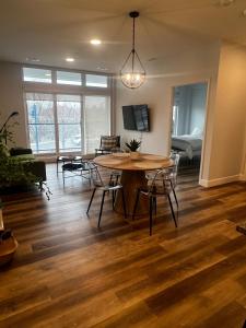 a living room with a wooden table and chairs at New The Carlyle 209 Beachside Condo in Grand Bend in Grand Bend