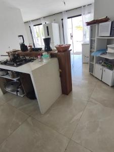 a kitchen with a stove and a counter top at Quintal da Gra in Araruama