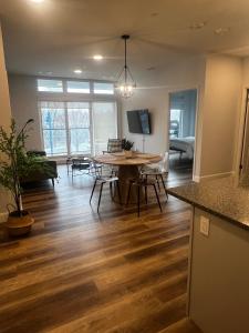 a dining room and living room with a table and chairs at New The Carlyle 209 Beachside Condo in Grand Bend in Grand Bend