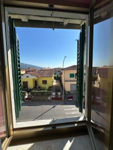 an open window with a view of a street at Casa Valeria in Pescia +13 photos