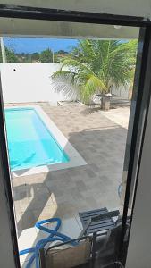 a view of a swimming pool and two chairs at Quintal da Gra in Araruama