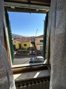 an open window with a view of a car at Casa Valeria in Pescia