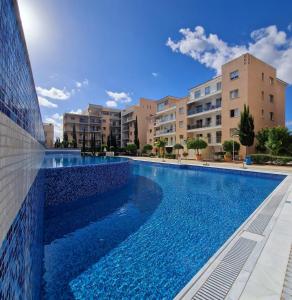 a swimming pool in the middle of a building at Stunning Sea View Resort Pools Spa Gym Balcony in Paphos