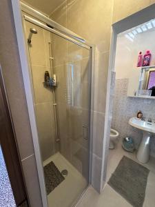 a shower with a glass door in a bathroom at Casa Valeria in Pescia
