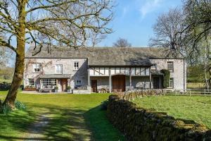 a large stone house with a stone wall at 3 Bed in Carr Bank oc-gl128 in Beetham
