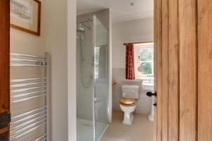 a bathroom with a toilet and a glass shower at 3 Bed in Carr Bank oc-gl128 in Beetham +24 photos