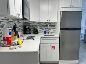 a kitchen with white cabinets and a refrigerator at 3315-Magic StudioCondo near Universal in Orlando