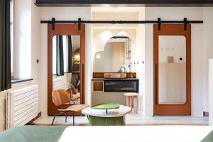 a small kitchen with a table and two chairs at AUBERGE FRANKENBOURG in La Vancelle