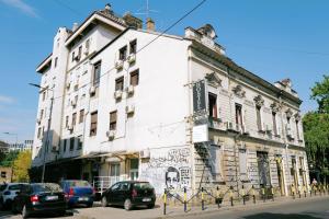 a white building with graffiti on the side of it at Oneone eleven hostel in Belgrade