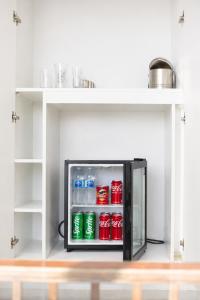 a refrigerator filled with soda cans in a room at Vetho Villa in Cape Town