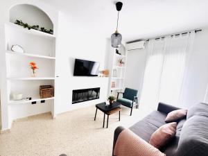 a living room with a couch and a fireplace at Sala 8 Gran Cinema in Sanlúcar de Barrameda
