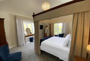 a bedroom with a large bed with a canopy at Aberdunant Hall, Snowdonia in Porthmadog