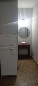 a kitchen with a refrigerator and a table with a mirror at Los Cactus 2 in La Rioja