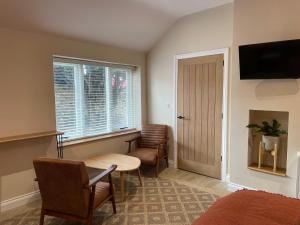a room with a bed and a table and chairs at Rooms at Allium in Tenby +38 photos