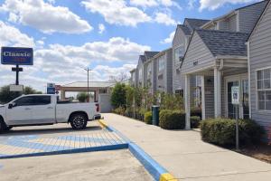 a white truck parked in front of a gas station at Classic Inn San Marcos, TX in San Marcos