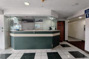 a restaurant with a counter in the middle of a room at Classic Inn San Marcos, TX in San Marcos