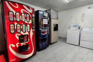 a coca cola vending machine in a room at Classic Inn San Marcos, TX in San Marcos