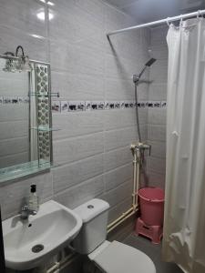 a bathroom with a white toilet and a sink at Errachidia Airport Apartment AC 15 Min Walk to Airport Gateway to Merzouga in Oulad el Haj