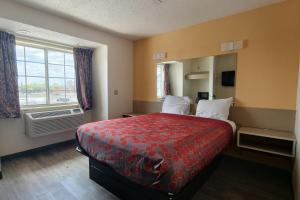 a hotel room with a bed and a window at Classic Inn San Marcos, TX in San Marcos +13 photos