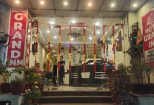 a woman standing in front of a room with red and yellow ribbons at Hotel Grand Inn in Haridwār +21 photos