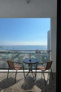a table and two chairs on a balcony with a view at STAYLUXIA - MANILABAYVIEW - Luxury and Superior Suites with, Balcony -except Studios- Pool, Netflix & Gym- Housekeeping Available - in Manila