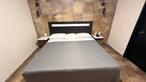a large bed in a room with two pillows at Hotel Florida, Centro Histórico in Mexico City +29 photos