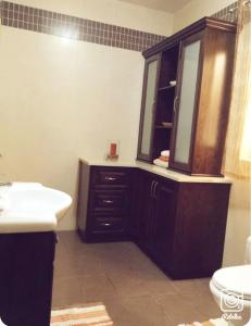 a bathroom with a sink and a mirror at Comfy & Spacious 1BDR 3 Min to Beach in Marsalforn