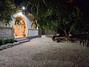 a building with a courtyard with a bench and a table at Hakuna Marika in Umbuji +6 photos