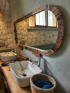 a bathroom with a sink and a mirror on a counter at Hakuna Marika in Umbuji