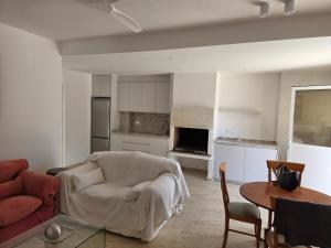 a living room with a couch and a table at Planta baja junto al mar con barbacoa in El Brosquil +8 photos