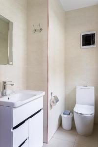 a bathroom with a white sink and a toilet at Olchazor hotel in Tashkent