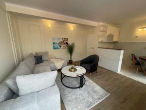 a living room with a couch and a table at Guest house Villa Slavica in Sveti Stefan