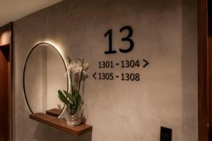 a bathroom with a mirror and a clock on the wall at Américas Benidorm Hotel in Rio de Janeiro +34 photos