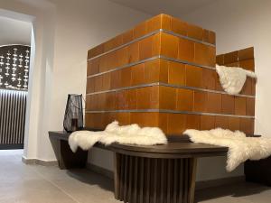 a room with a wooden wall with faux fur at 4 Elements Resort Bled in Bohinjska Bela +27 photos