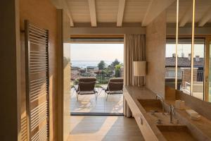 a bathroom with a sink and a view of a patio at Pool Villa Lazise in Lazise
