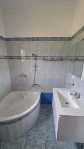 a bathroom with a white tub and a sink at Anemos House Sykia Halkidiki in Sykia Chalkidikis +24 photos
