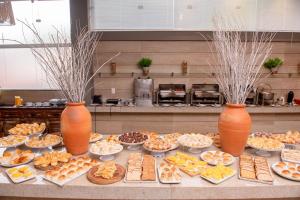 a table with many different types of food on it at Hotel Vila Verde in Nova Friburgo +142 photos
