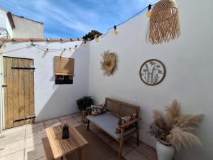 a patio with a couch and a table at Ch'ti Camargue in Port-Saint-Louis-du-Rhône