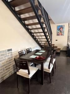 a dining room with a table and chairs and a staircase at La Sabelona in Otero de Sanabria